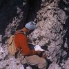 "Toto" signing the route register, which is on a ledge one pitch below the summit.