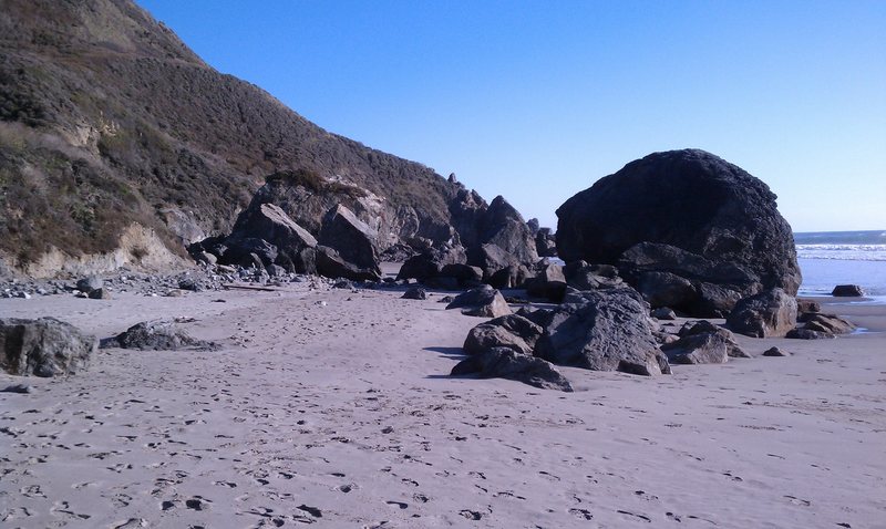 Numerous boulders SE of Stinson beach with a variety of routes. View from the NW.