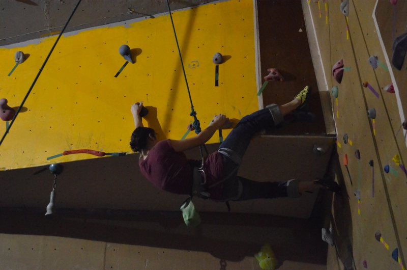 Emily Dale heel hooking the overhang in the Amphitheater. Photo by Jack Lee.