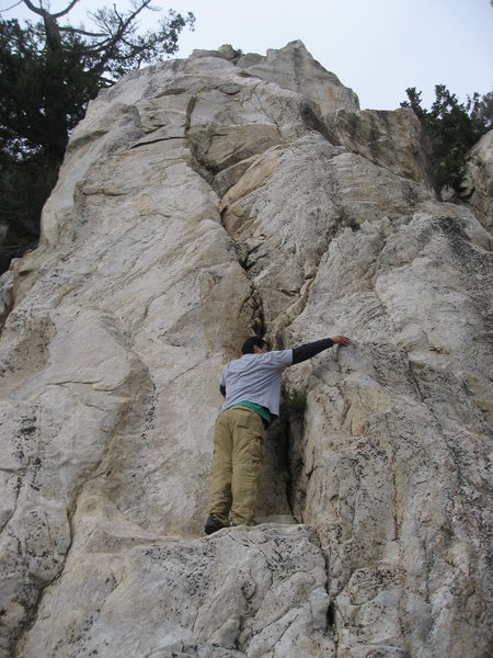 Climb up the crack to a small ledge followed by an easy face to the top.