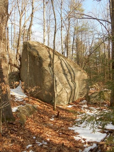 The first boulder you pass on your left after walking past hero block