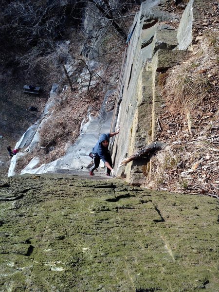 Shan gets ready to make the delicate turnaround (crux move) on Dichotomy.