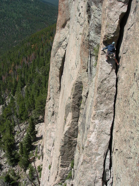 Wise climber staying OUTSIDE the crack approaching the wide section.