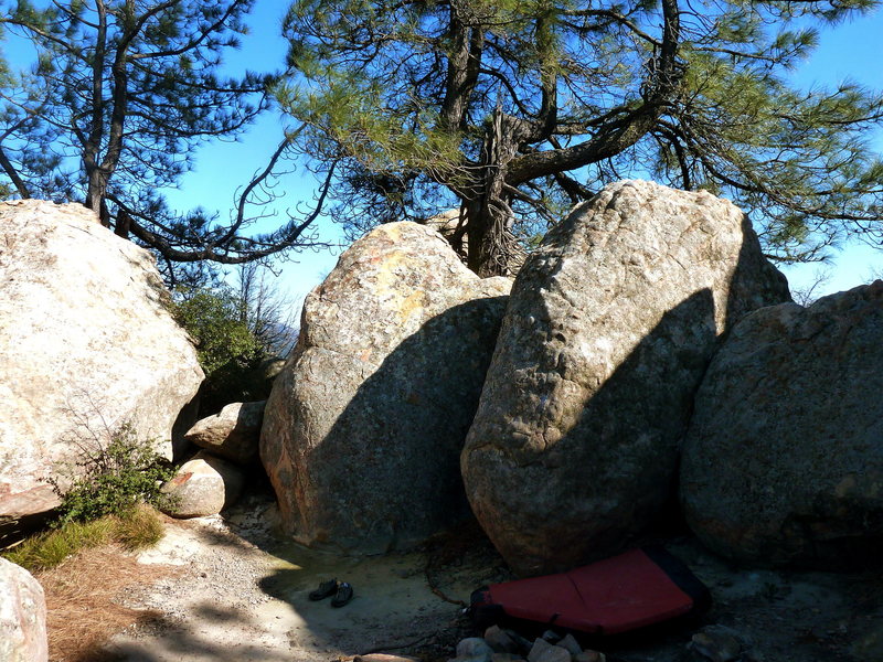 Courtyard Squeeze follows the narrow face to the left of the rightward trending arete on the right boulder.