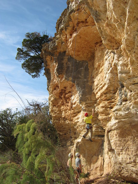Climber on Rockabout 10a, which goes up the gray face and to anchors at the left. Rope on right is running thru draws on Happy Things 11a.