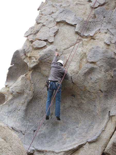 Richard Alden, hanging the pre-crux move above the dish on Pancakes and Cornflakes.