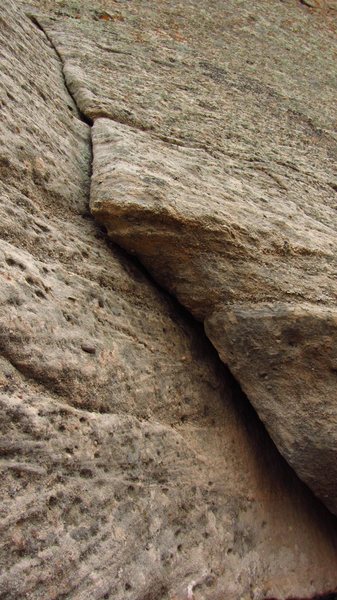Layback start. The only 5.8 move is laying back and getting your feet up high onto the rock.