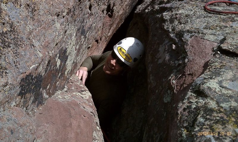 Crawling out of the cave on the 2nd pitch of the 4th Flatiron. Note: don't wear a pack.