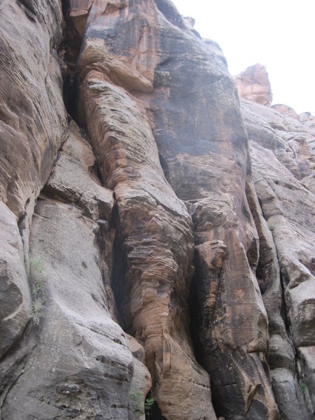 Cherry Twist climbs the rounded arete to the short black face above.