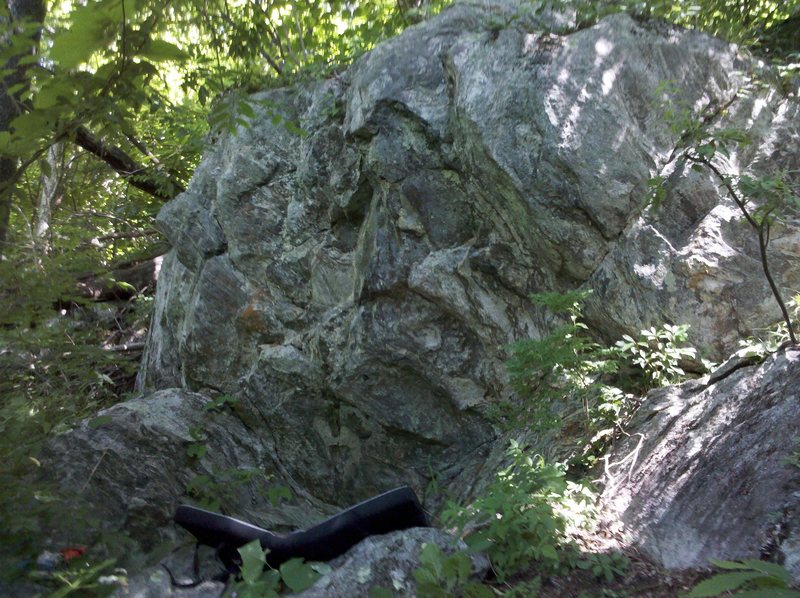Wake and Bake follows the center/slightly right of center line up the first short overhanging boulder up the bouldering trail...Pack It Up starts above the crease in the crashpad on the chalked up hold.