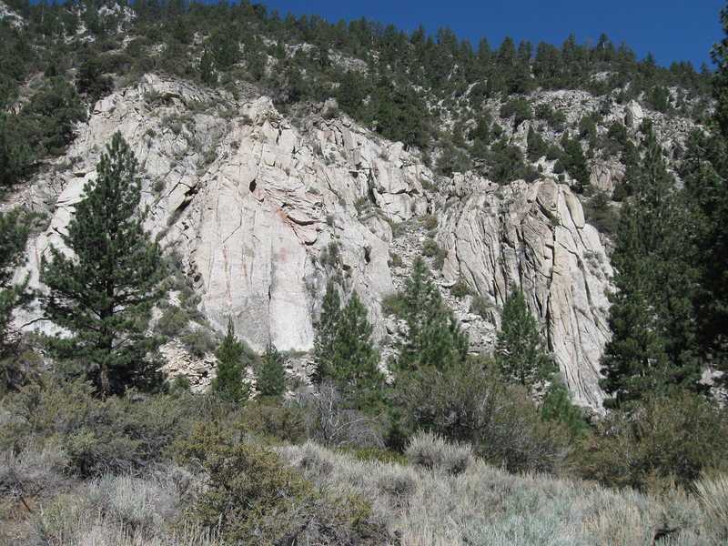 The view of the North Buttress from Highway 395. Jerry Jeff Walker climbs the prominent dogleg crack on the left (main) face.
