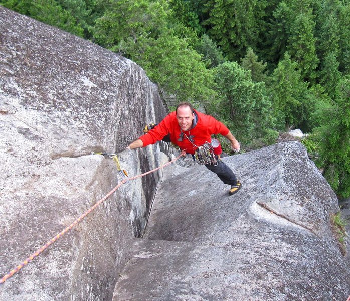 Derek Pearson at the top of A Ship Called Black Rock (5.10c/d). <br>
<br>
The white horn of rock in the distance (below & right of climbers left foot) is the anchors at the top of p1 of Law and Order.