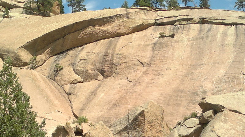 Looking west at the full route + Optical Illusion. Climb the crack to the left tree, traverse right on the bottom crack (the top crack is O.I.).