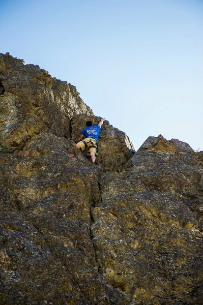 Scott following, at the crux move. Photo Credit Claire Brady.
