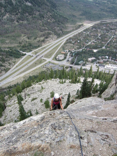 Beth following the easy slab on the upper head wall before the traverse left.