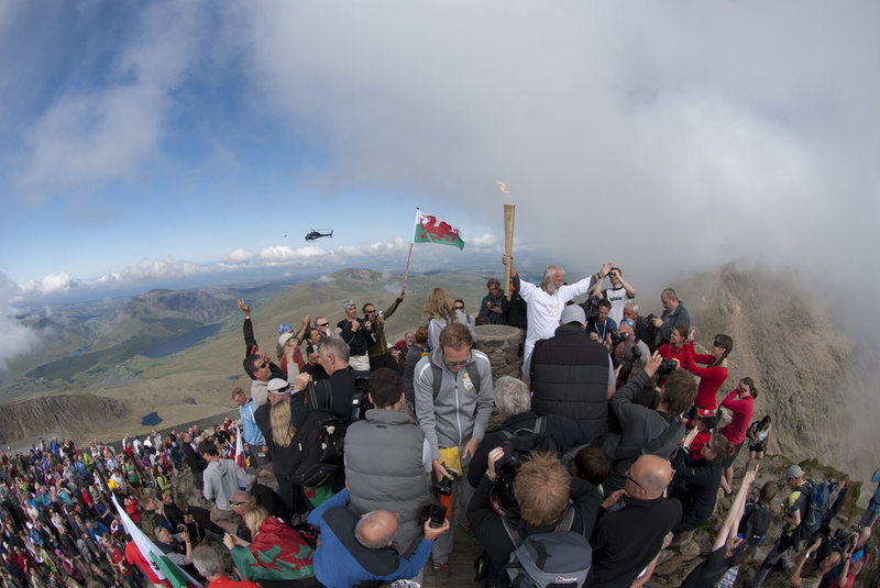 Chris Bonington on the summit of Snowdon with the Olympic torch