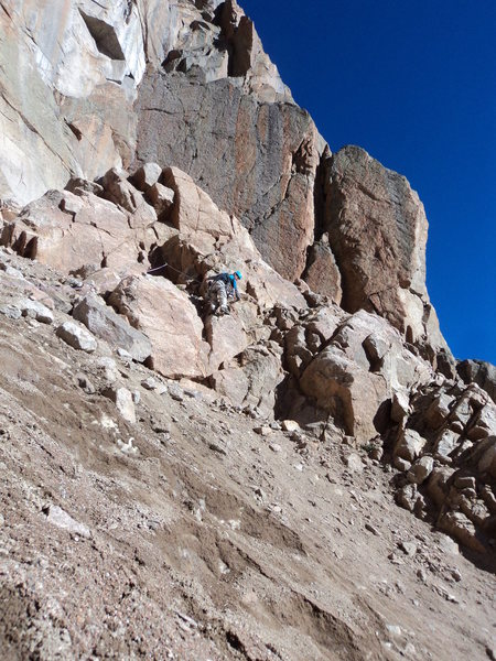 Joe starting P1 of the route (left start) after crossing scree on hard snow. Do not go too high here. You aim for below the lowest notch on the skyline.
