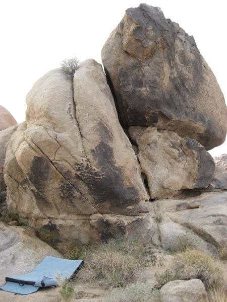 The bouldering pad in this picture is not under the starting point of High Priest Melchizedek, which is a little more to the right under the dark rock face.