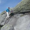 Traversing a slab of adirondack granite on a windy descent of Colden.