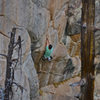 Tall climber beginning the short person crux.  Photo: John Hinrichsen.