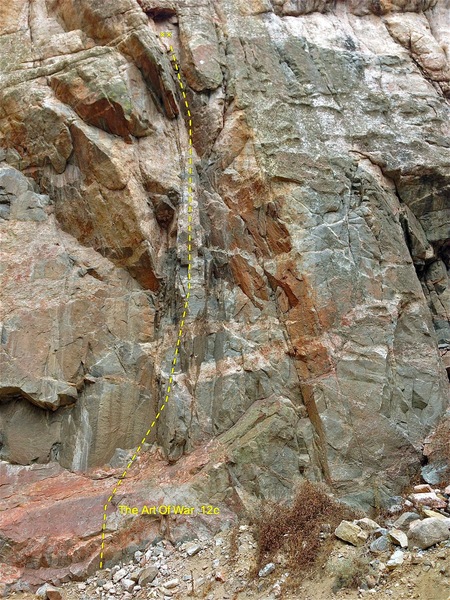 The Art Of War 5.12c. The route is in the center of the photo. It ascends the blocky arrowhead feature and finishes in a chimney.