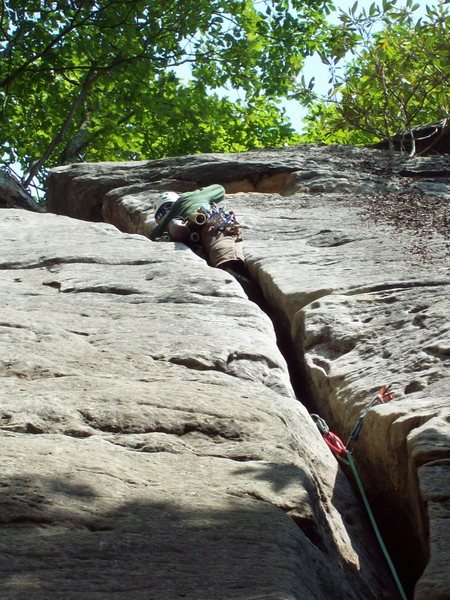 Canadian fire fighter Dave Brown has a thing for off width cracks. Here getting in to the Crescent Moon. Photo: John Ely