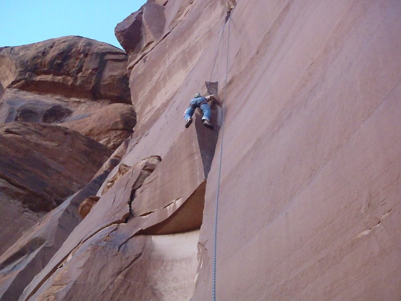 Leaving the crack for a stance on the ledge.
