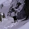 Old VHS screen capture of John Fujii coming up the right branch of Red Slate North Couloir, in winter conditions.