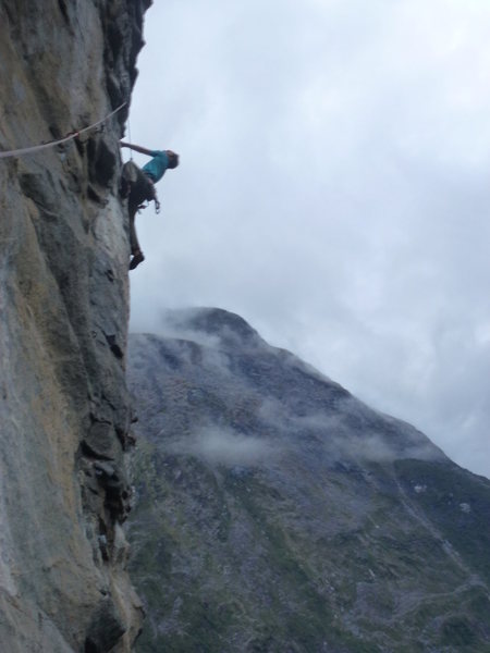 Climbing a unknown climb, a 10 minute walk from the road. While driving in Milford Sound, you can't miss this climbing wall on your right. Cairns and a small bridge mark where to park.
