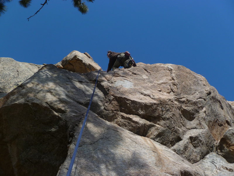 Above the first two bolts.