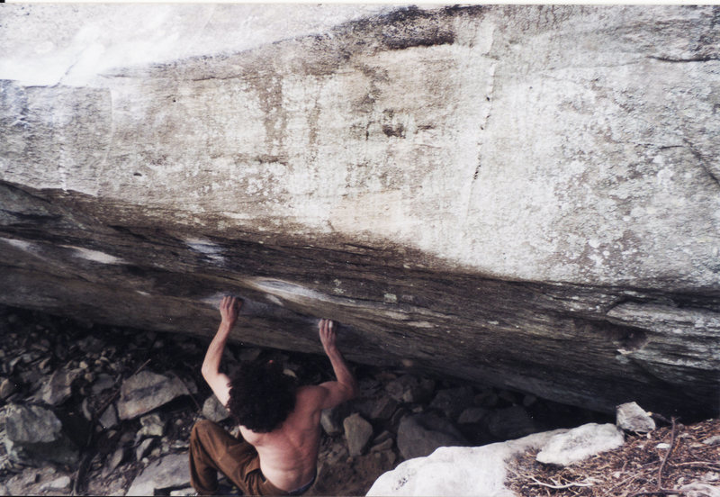Pulling off the ground ready to do the crux snatch on Two Pop V9 Lost Cove, North Carolina in 2003. This was taken the day I sent. There are no feet for this move it is completely campus and also very difficult not to dab on the rock to the right. I had already injured my right ring ringer A2 pulley mainly due to trying this problem so many times. The send took no less than 80-100 tries over 3 or 4 days on 2 trips. It is the most attempts I have put into a single problem.