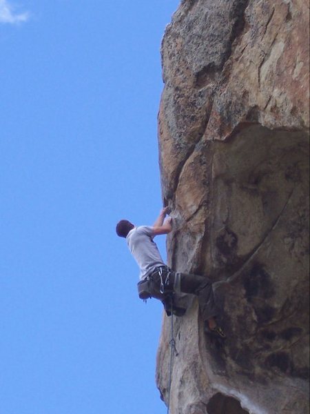 Pulling the exposed and awesome crux move onto the face.