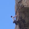 Pulling the exposed and awesome crux move onto the face.