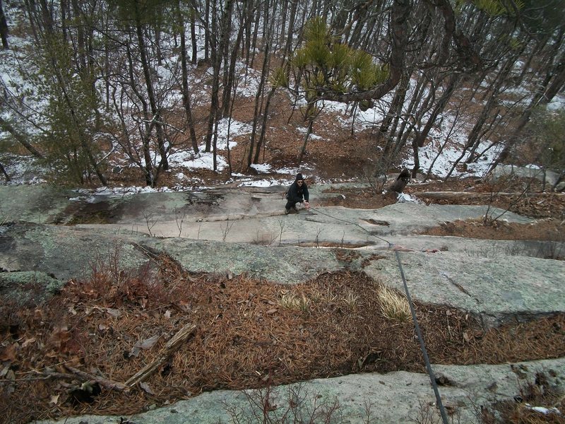 Josh gaining the slab and warming the hands for this early spring climb.