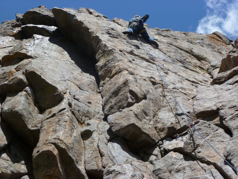 Above the second bolt.
