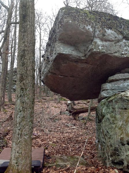 "Legion" (V7) stand starts under the roof on the low block and climbs directly out, topping out straight over the upper block.