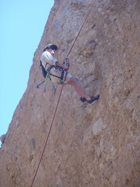 A climber rappelling down the line of "Middle Earth."