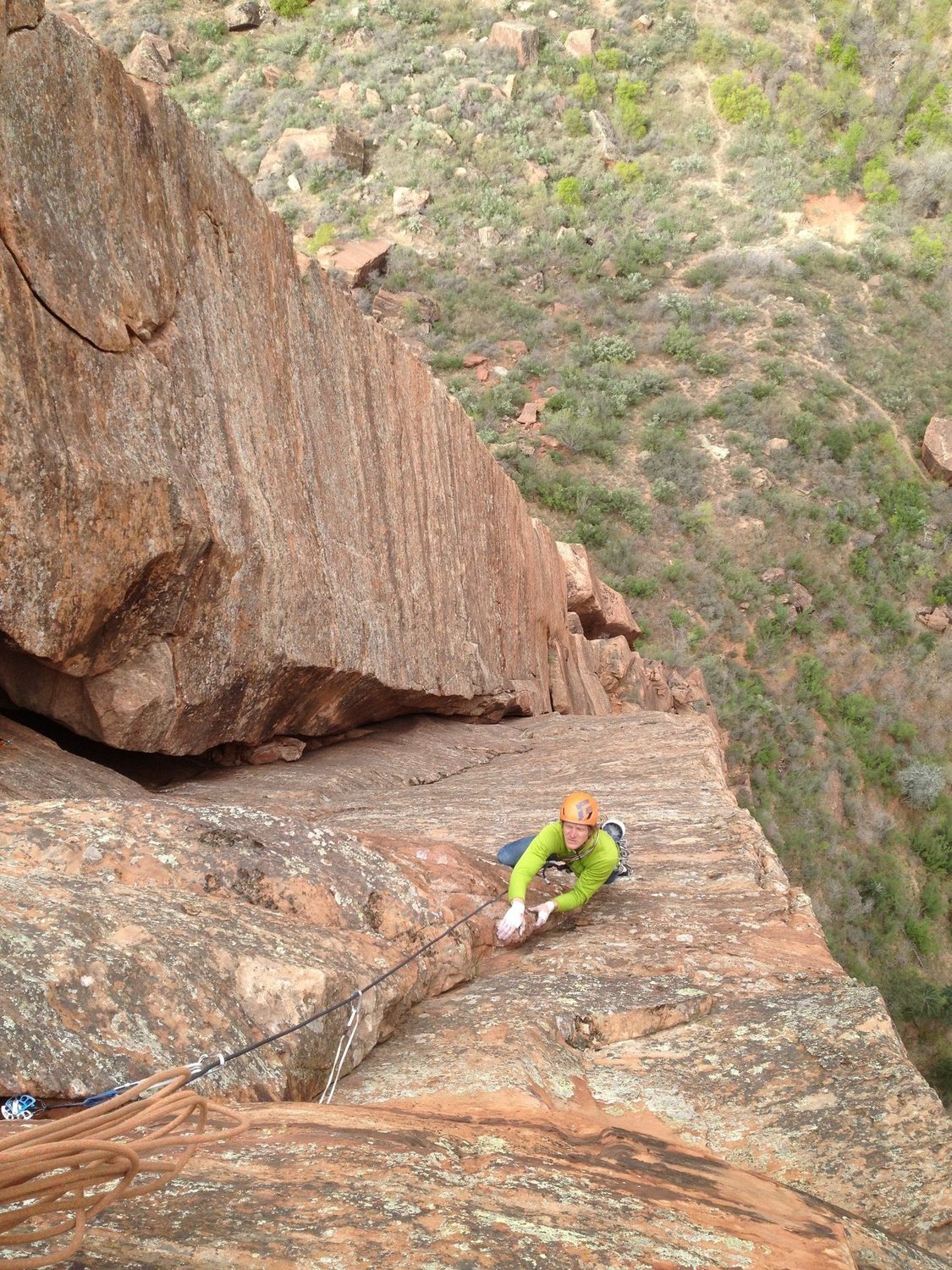 Hansen cleaning up the thin face traverse pitch on Shune's Buttress.