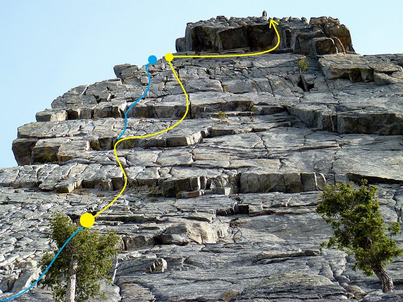 A cool variation I have concocted after climbing this thing several times. This variation includes a couple of the best features on this wall IMO -A great section of splitter hands, and a beautifully exposed traverse beneath the summit roof. From lunch ledge, climb a full 60m into a fairly obvious alcove for a comfortable belay ~10m below the first of 3 short "roofs". (A 60m rope is just enough not a rope stretcher). From here work over the first two small "roofs" trending right to what looks like a flaring fists roof at the start of the splitter. Avoid climbing too high and traversing under the roof into the splitter. The small "roof" and splitter are actually very secure and easy hands on a featureless face. After 55m there is a nice belay in a small alcove just right of the walk up ledge entrance. Traverse under the roof (stay low). Place a piece and make the transition onto the vertical face at the end of the traverse. Climb up a short section of buttlips corner to the summit. All the climbing on this variation is very protectable. Due to the long pitches I recommend bringing doubles to 3 and rationing gear placements.