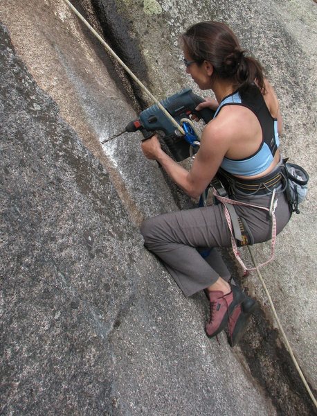 The first ascentionist putting in some elbow (and knee) grease