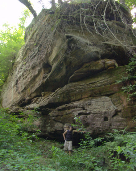 A good size sandstone outcropping on the south side of the creek. Grade rises up to the south (left in the photo) allowing for top roping from solid trees above.