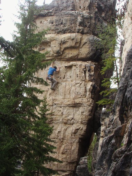 Laid Back, 5.11c<br>
This is the middle route on the blonde side of a free standing pillar in The Shadowlands.<br>
<br>
Spearfish Canyon, South Dakota.
