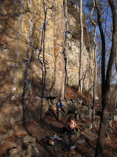 Me leading Grey Matter. You can see the rocks below the first bolt and how close the tree is to the arête.