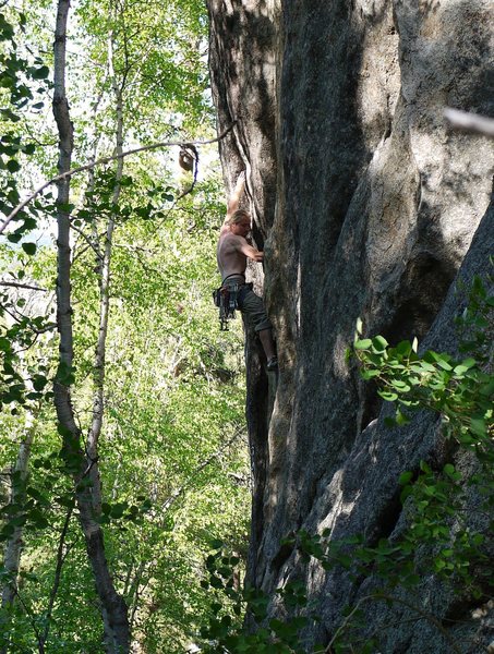 SteveZ sending Slang, a powerful 5.12- to the left of Evergreen on the smaller formation. See the Busse guide.
