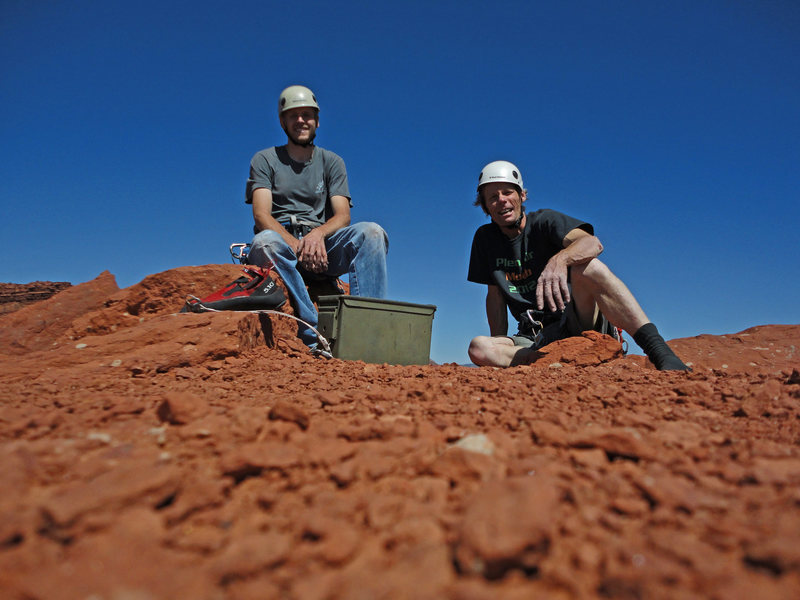 Low angle summit shot of Colby Wayment and Eric Zschiesche atop The Titan on a warm June day of 2013. Sans humans and gear,... with less atmospheric blue,... Mars? Classic formation,... though,... Zschiesche taxed with entertaining techniques ( aiding and jugging ) long rusty,.... was almost tempted to forego the last pitch and rappel. Clouds of consternation waned,... and the Sun baked summit felt the shadowed presence of members of the Tribe Primate....