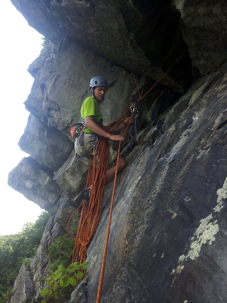 Ryan at the P1 hanging belay at the end of the delicate traverse. P2 follows the crack over his head around the corner behind him.