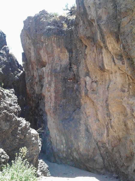 The entrance to the Tollgate Pass routes. The routes start here, and continue up the winding crevice. As stated above, the rock is in the shade and very smooth. The trail is very loose rock, but there are plenty of cairns leading here