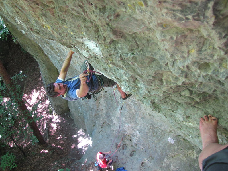 Me clipping the 3rd bolt, with the last good hold visible which marks the start of the crux.