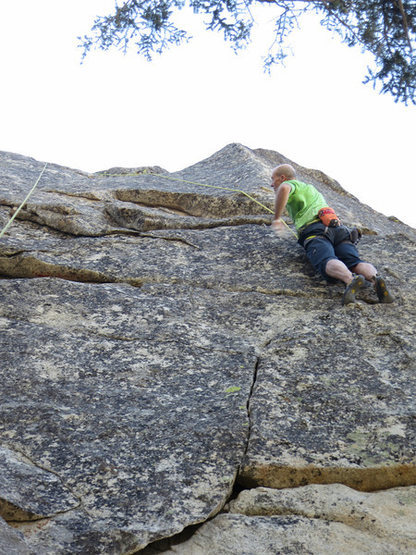 Rick just past the first crux of Powder Finger. Head up the right curving finger crack to gain the ledge.
