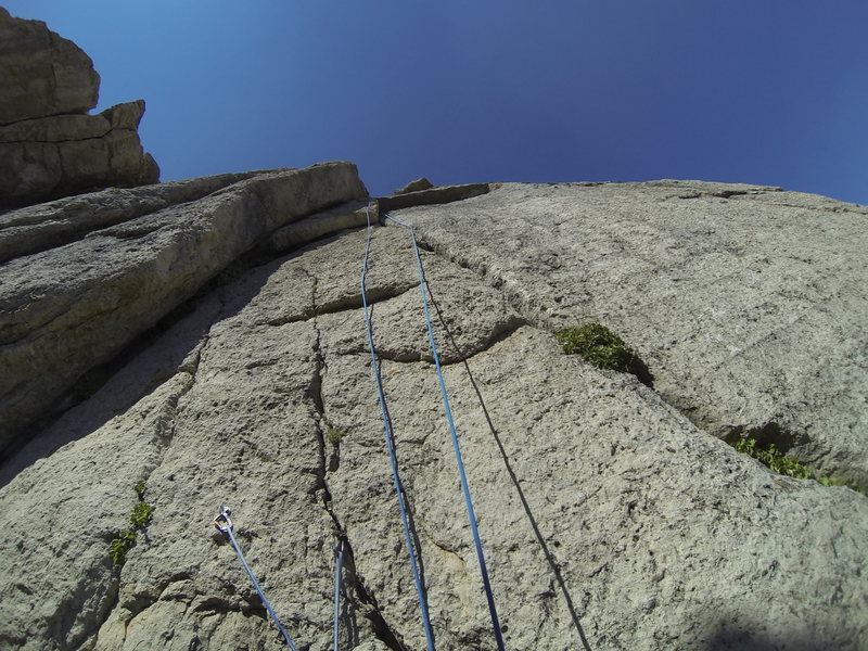 Looking up the route from the belay ledge. The belay ledge is large and flat but there is one bolt and a piton you can anchor on as well.